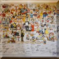 A08. Unframed cartoon poster with printed signatures. 26” x 34” - $40 